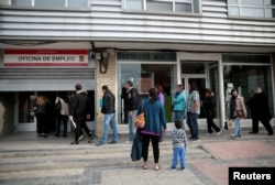 FILE - People enter a government-run job centre in Madrid, Spain, April 27, 2016.