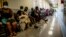 FILE - People queue to get vaccinated against COVID-19, at Lenasia South Hospital, near Johannesburg, South Africa, Dec. 1, 2021.