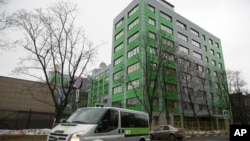 FILE - In this file photo taken Oct. 27, 2017, a car of Russian state-owned television station RT passes by the company's office in Moscow. 