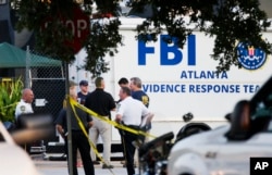 Law enforcement officials gather outside the Pulse nightclub, the scene of Sunday's mass shooting in Orlando, Florida, June 15, 2016.
