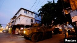 Brazilian Marine's armored vehicles patrol the Mare slums complex in Rio de Janeiro, March 30, 2014. 