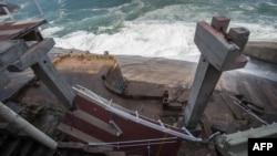 A portion of an elevated bike path lies below the rest of the structure after the route collapsed in Rio de Janeiro, Brazil, April 21, 2016. Two people were killed in the accident.