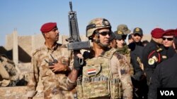Iraqi soldier stands guard as army generals gather for news conference announcing their victory in Gogjali, a village on the edge of Mosul, Iraq, Nov. 3, 2016. (Photo: Jamie Dettmer for VOA) 