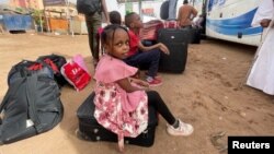 People gather as they flee clashes between the paramilitary Rapid Support Forces and the army in Khartoum, Sudan April 24, 2023. 