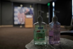 FILE - Bottles of hand sanitizer are placed near reporters as Democratic presidential candidate, Sen. Bernie Sanders, I-Vt., speaks about coronavirus in Burlington, Vt., March 12, 2020.