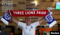 FILE - LGBT rights campaigner Di Cunningham displays a scarf during an interview with Reuters in Volgograd, Russia, June 18, 2018.