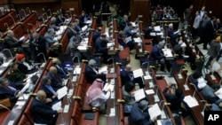 Members of Egypt's panel tasked with amending Egypt's Islamist-drafted constitution, read drafts of the constitution before they begin voting on a series of amendments, Cairo, Egypt, Saturday, Nov. 30, 2013. 