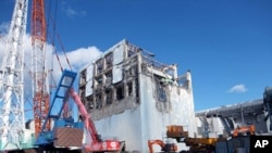 The crippled Fukushima Daiichi nuclear power plant's No.4 reactor building is seen after the removal of debris on the upper side of the unit in Fukushima prefecture, January 5, 2012