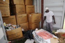 FILE - An agent stands next to a container full of illegal and fake drugs seized by Ivorian authorities in Abidjan, Ivory Coast, Nov. 6, 2018.