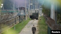 FILE - A South Korean soldier walks along a military fence near the demilitarized zone separating the two Koreas in Paju, South Korea, Sep. 28, 2021. 
