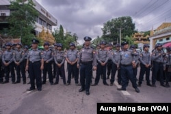 Police in Yangon’s Bahan Township block protestors.