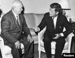 FILE – U.S. President John F. Kennedy, right, meets with Soviet Premier Nikita Khrushchev at the U.S. Embassy residence in Vienna, Austria, in this June 1961 handout image.