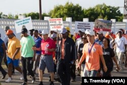 Chinese Ambassador to Tanzania Lu Youqing walks with Tanzanian officials, celebrities and conservationists during the ‘Walk for Elephants’ march in Dar es Salaam.
