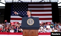 U.S. President Donald Trump reacts while speaking to supporters during a rally in Panama City Beach, Florida, May 8, 2019.