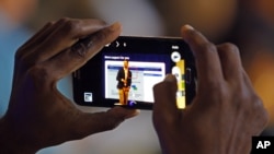 An attendee captures the keynote speech from Facebook's director of small business Jonathan Czaja at Facebook's Boost Your Business Nashville event held at Marathon Music Works on Thursday, Aug. 27, 2015, in Nashville, Tenn. (Photo by Wade Payne/Invision