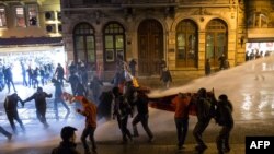Police use a water cannon to try to disperse people protesting against newly proposed restrictions on the use of the internet and against the Turkish government during a protest on the Istiklal Avenue in Istanbul, Jan. 18, 2014. 