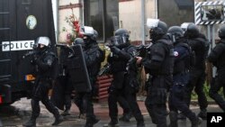 French police patrol in Longpont, north of Paris, France, Jan. 8, 2015. 
