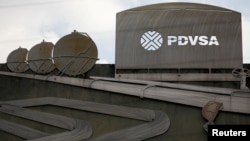 utouts depicting images of oil operations are seen outside a building of Venezuela's state oil company PDVSA in Caracas, Venezuela Jan. 28, 2019.