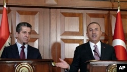 Turkey's Foreign Minister Mevlut Cavusoglu, right, and Masrour Barzani, Prime Minister of Iraqi Kurdish Regional Government, speak to journalists after their talks, in Ankara, Turkey, Nov. 28, 2019.