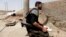 A Free Syrian Army fighter holds his weapon in Raqqa province, east Syria, May 6, 2013. 