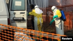 A health worker sprays disinfectant on an ambulance at a Health Centre in Goma, Democratic Republic of Congo, July 18, 2019. 