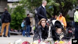 A woman lays a bouquet of flowers in the London Bridge area of London, June 5, 2017.