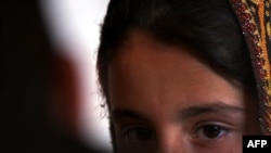 FILE - A young Pakistani girl who escaped a forced marriage speaks to a reporter in the country's northwest. 