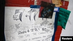 A photo of Eric Garner is displayed at a makeshift memorial, where he died during an arrest in July, at the Staten Island borough of New York, Dec. 3, 2014.