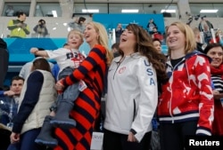 U.S. President Donald Trump's daughter and senior White House adviser Ivanka Trump holds Luke Shuster, son of skip John Shuster of the U.S., next to athletes Cory Christensen and Rebecca Hamilton during the men's final. The U.S. upset Sweden to win the gold.