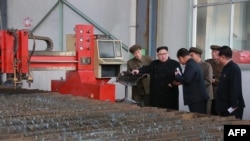 FILE - North Korean leader Kim Jong Un, center, visits the March 16 Factory at an undisclosed place in this undated picture released from North Korea's official Korean Central News Agency (KCNA) on Nov. 4, 2017. 