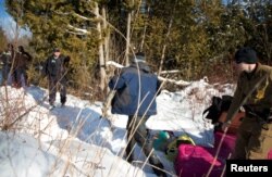 A man who claimed to be from Sudan runs for the border after his family crossed the U.S.-Canada border into Hemmingford, Canada, from Champlain, New York, Feb. 17, 2017.