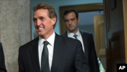 FILE - Republican Sen. Jeff Flake arrives before Secretary of State John Kerry, Secretary of Energy Ernest Moniz and Secretary of Treasury Jack Lew, arrive to testify at a Senate Foreign Relations Committee hearing in Washington, July 23, 2015.