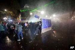 Police use a water cannon to prevent protesters pouring into the streets of Tbilisi Georgia, following Georgian Prime Minister Irakli Kobakhidze's announcement, Nov. 29, 2024.