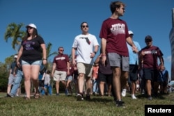 Students and parents arrive for voluntary campus orientation at the Marjory Stoneman Douglas High School, Feb. 25, 2018. The school reopens Wednesday, following the Valentine's Day mass shooting in Parkland, Florida.