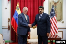 Venezuela's President Nicolas Maduro shakes hands with U.S. diplomat Thomas Shannon during their meeting at Miraflores Palace in Caracas, Venezuela, June 22, 2016.