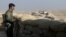 A militiaman of the Kurdistan Freedom Party, an Iranian Kurdish opposition group, looks over the sandbags at a section of the frontline near the Iraqi city of Kirkuk, Sept. 5, 2016.