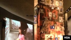 Inside the National September 11 Memorial Museum, the last World Trade Center column to be cut away from Ground Zero is covered in graffiti messages by those who cleared the site after the attack, Ground Zero, New York City, May 15, 2014. (Adam Phillips/V