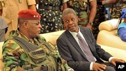 Guinea's acting president General Sekouba Konate, left, speaks with Prime Minister of the transitional government Jean Marie Dore during the inauguration ceremony of Camp Boiro in Conakry, (file photo)