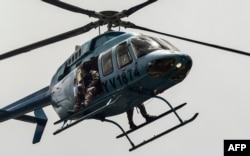 Security forces overfly Venezuela's third city, Valencia, as anti-government activists demonstrate, Aug. 6, 2016.