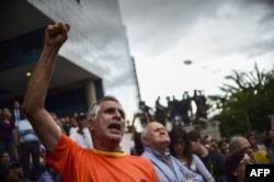 Venezuelans protest against President Nicolas Maduro, in Caracas, July 31, 2017.