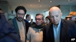 FILE - Pablo Beltran, center, commander and chief negotiator for the rebel National Liberation Army, ELN, Ivan Cepeda, left, and Jose Otty Patiño, negotiators for the Colombian government, at peace talks in Bogota, Colombia, Oct. 10, 2023.