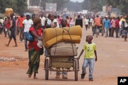 FILE - A family with there belongings on a makeshift trolley in the city of Bangui, Central African Republic, as clashes sectarian clashes erupted between rivaling Christian and Muslim militias, Sept. 30, 2015.