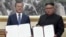In this image made from video provided by Korea Broadcasting System (KBS), South Korean President Moon Jae-in, left, and North Korean leader Kim Jong Un pose after signing documents in Pyongyang, North Korea, Sept. 19, 2018.