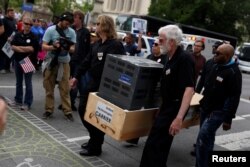 People protest against the outsourcing of jobs by Carrier at a rally hosted by the United Steelworkers and the AFL-CIO at the Statehouse in Indianapolis, Indiana, April 29, 2016.