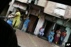 FILE - Sex workers are seen at a red-light area in Mumbai, India, Aug. 4, 2009.