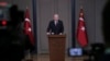 Turkey's President Recep Tayyip Erdogan talks to members of the media at the airport in Ankara, Turkey, before departing for a trip to France, Nov. 10, 2018.