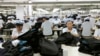 FILE - North Korean workers assemble Western-style suits at the South Korean-run ShinWon Corp. garment factory inside the Kaesong Industrial Complex in Kaesong, North Korea.
