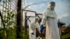 Medical staff are sterilized before entering the isolation unit at a hospital in Bundibugyo, western Uganda, on Aug. 17, 2018, where there is one suspected case of Ebola.