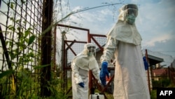 Medical staff are sterilized before entering the isolation unit at a hospital in Bundibugyo, western Uganda, on Aug. 17, 2018, where there is one suspected case of Ebola.