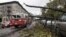 A fire truck passes a tree that has fallen across parked cars in Brooklyn, New York the morning after superstorm Sandy struck, Oct. 30, 2012.